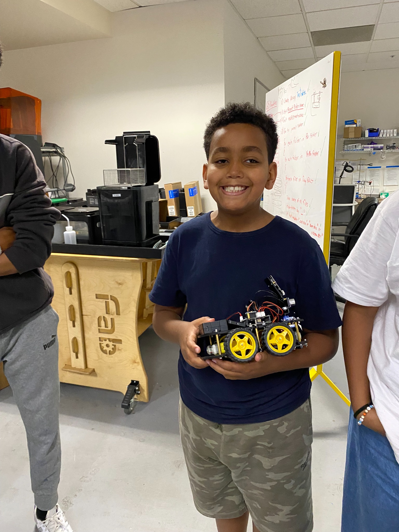 Prince Academy student holding a robotics project